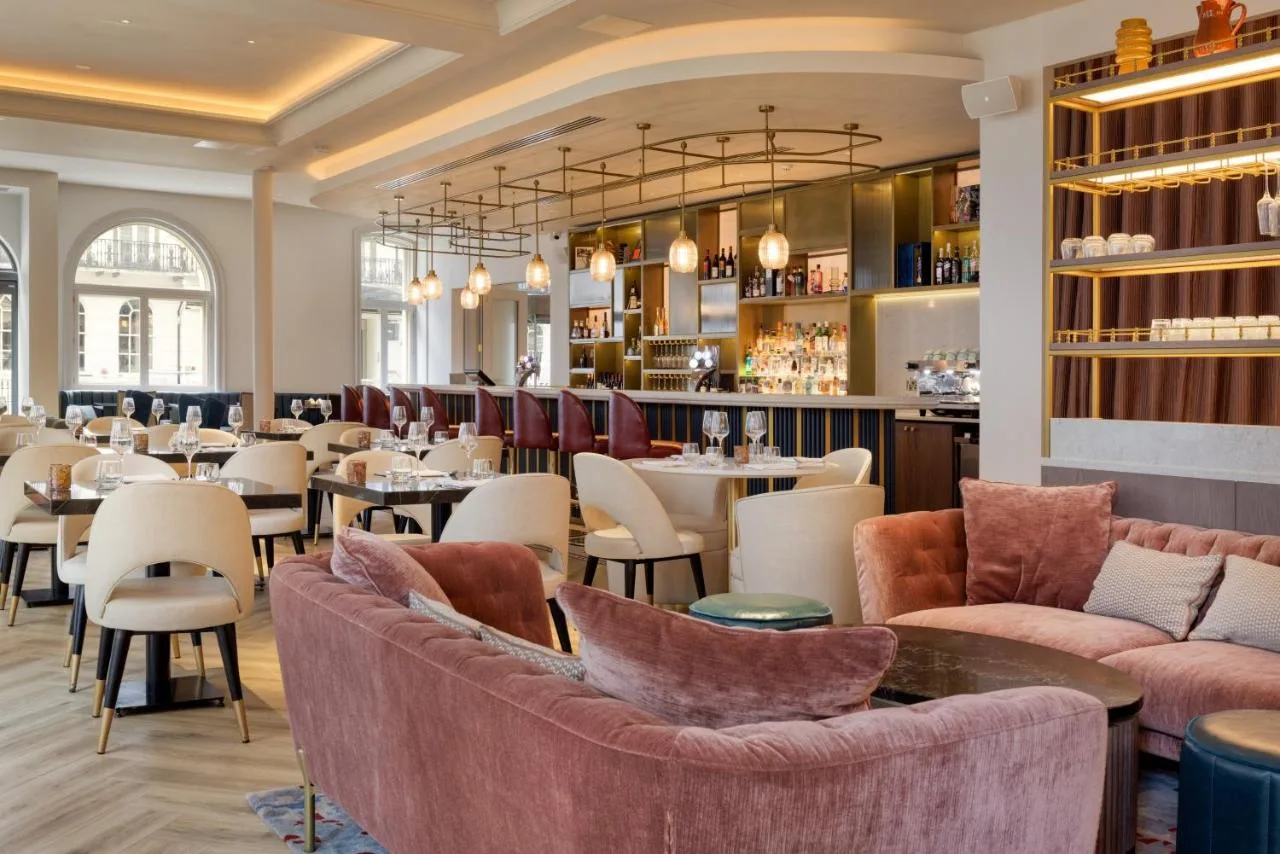 a restaurant with tables and chairs and a bar at The Memoir Club in London